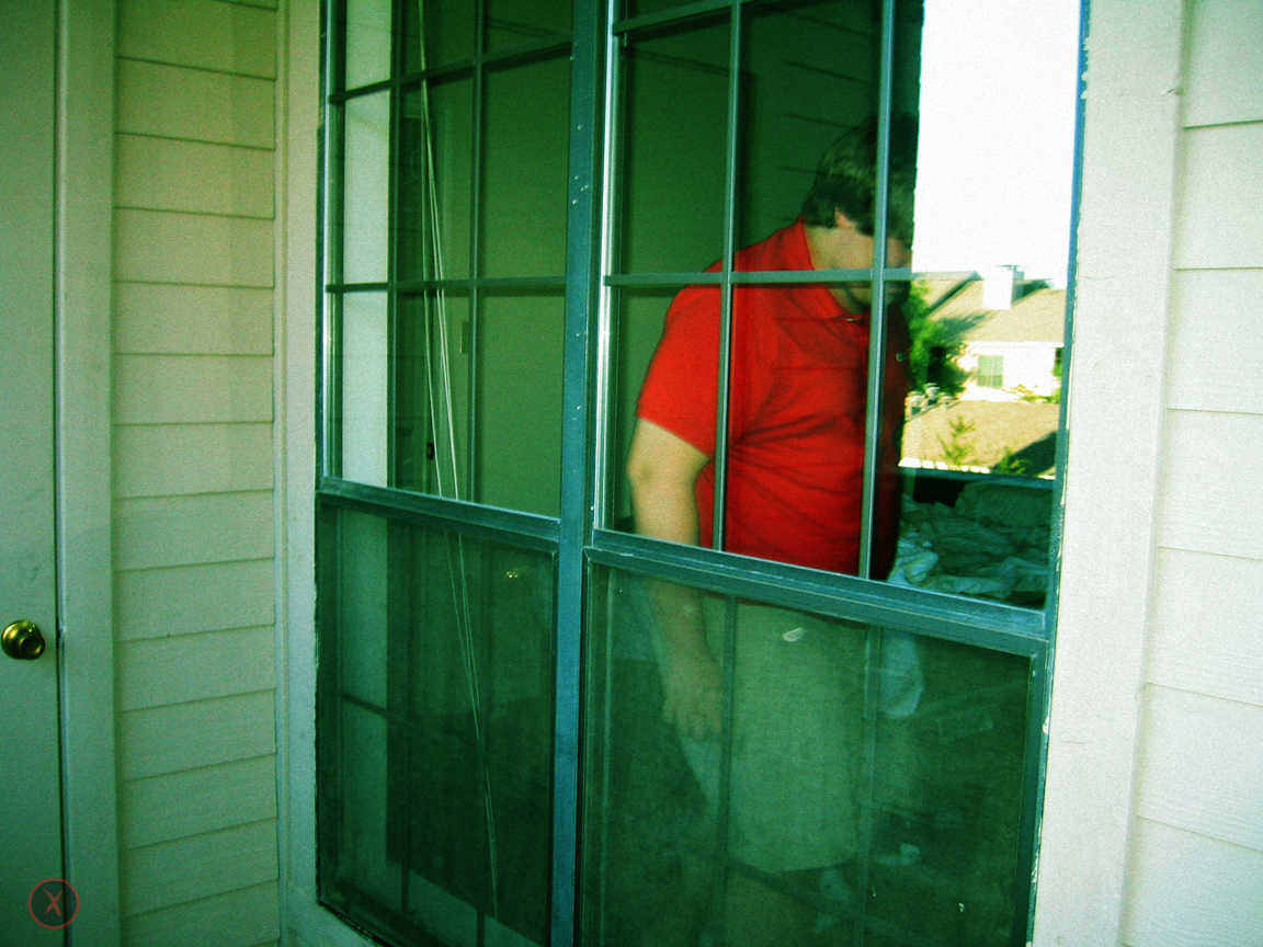 Sam is seen laughing on the other side of a window
