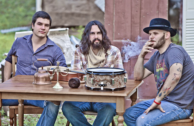 Daniel and The Kinfolk sit around a table with some antiques